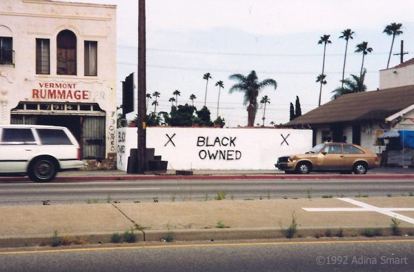 Black Owned spray painted on burnt down business.